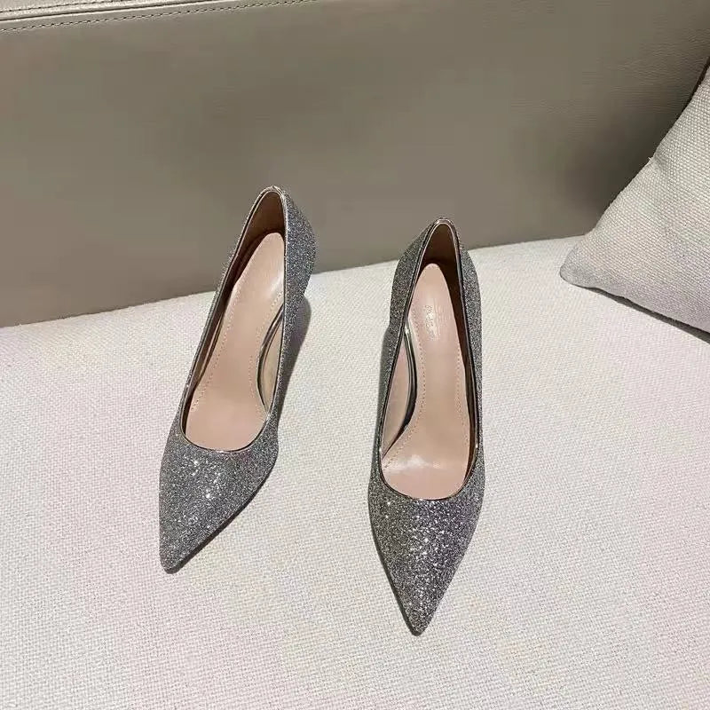 Women's silver and black stiletto wedding shoes with crystal detail on the heel.