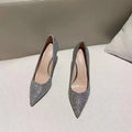 Women's silver and black stiletto wedding shoes with crystal detail on the heel.