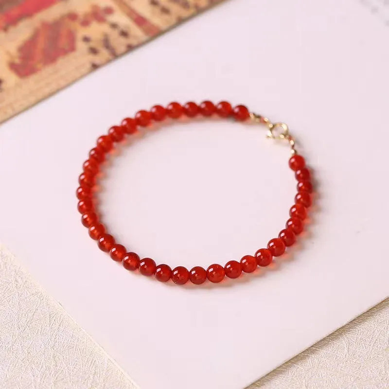 A classic style ultra-thin red agate bracelet for women on a white background.