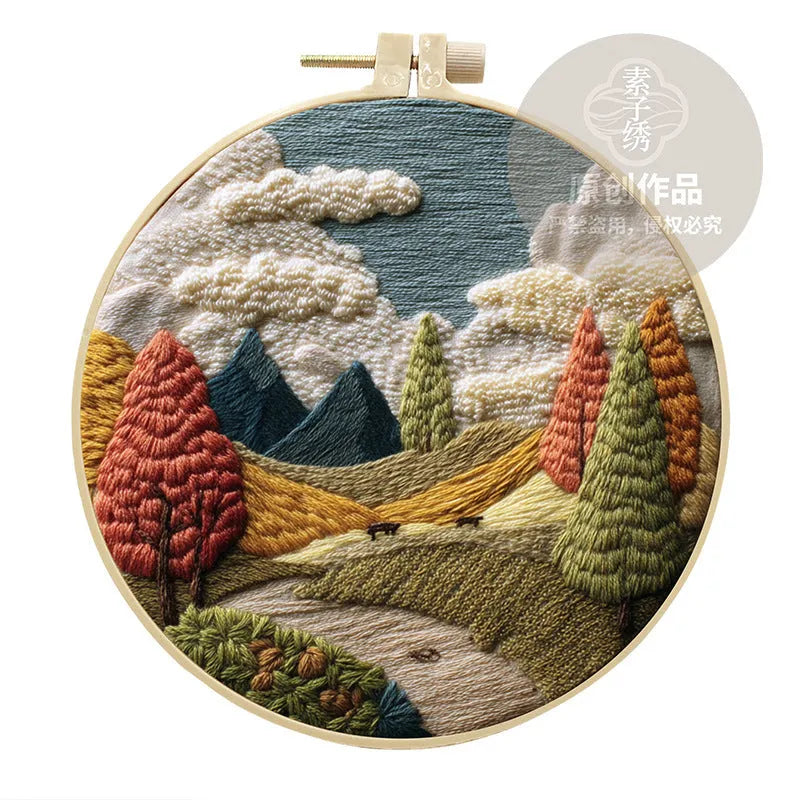 Embroidery DIY kit with cotton fabric, bamboo frame, scissors, and printed landscape pattern
