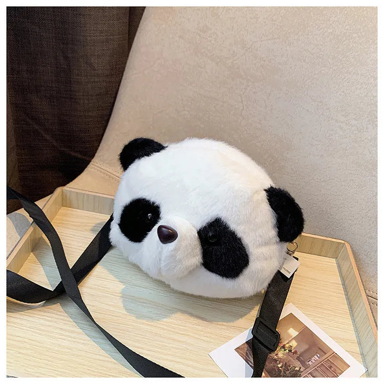Soft plush panda head crossbody bag with cylindrical shape and sandwich pocket.