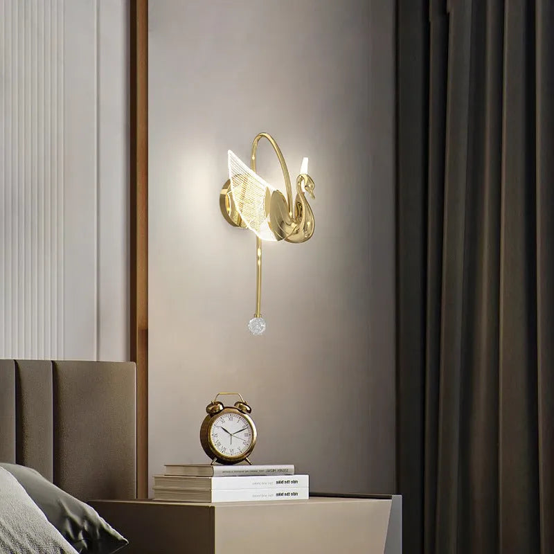 Minimalist swan-shaped wall lamp with gold finish and white acrylic shade.