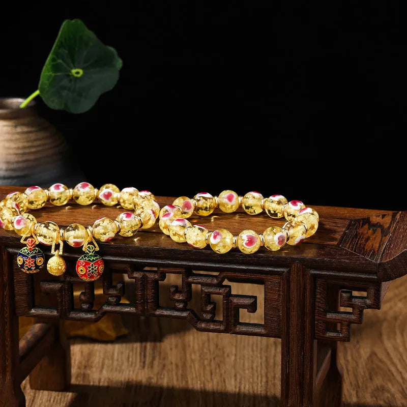 Handmade fluorescent glaze bracelet with swallowing gold beast motif on heart-shaped 10mm beads