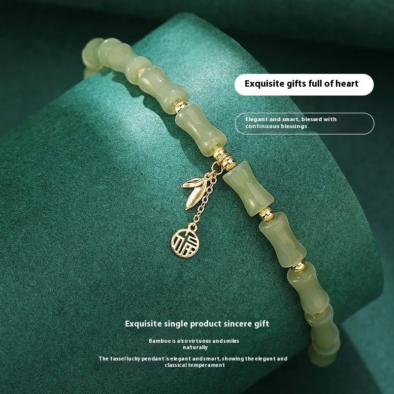 Green Chinese-style bamboo joint bracelet and necklace set made from alloy with Hetian jade accents.