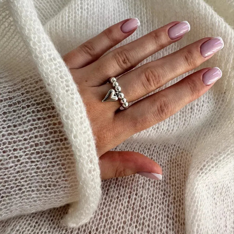 Handmade beaded elastic string love ring with geometric heart design in gold or white colours