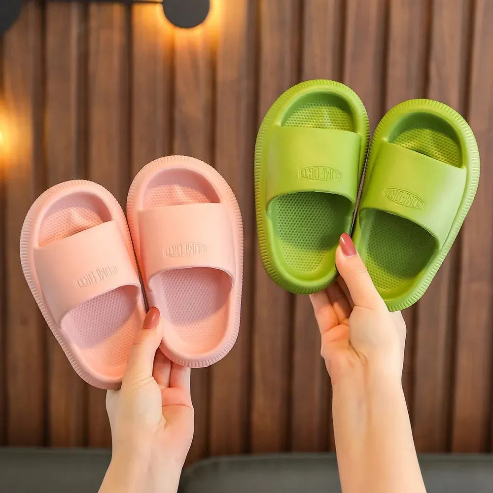 Children's bright coloured EVA slippers with a thick non-slip sole on a white background.