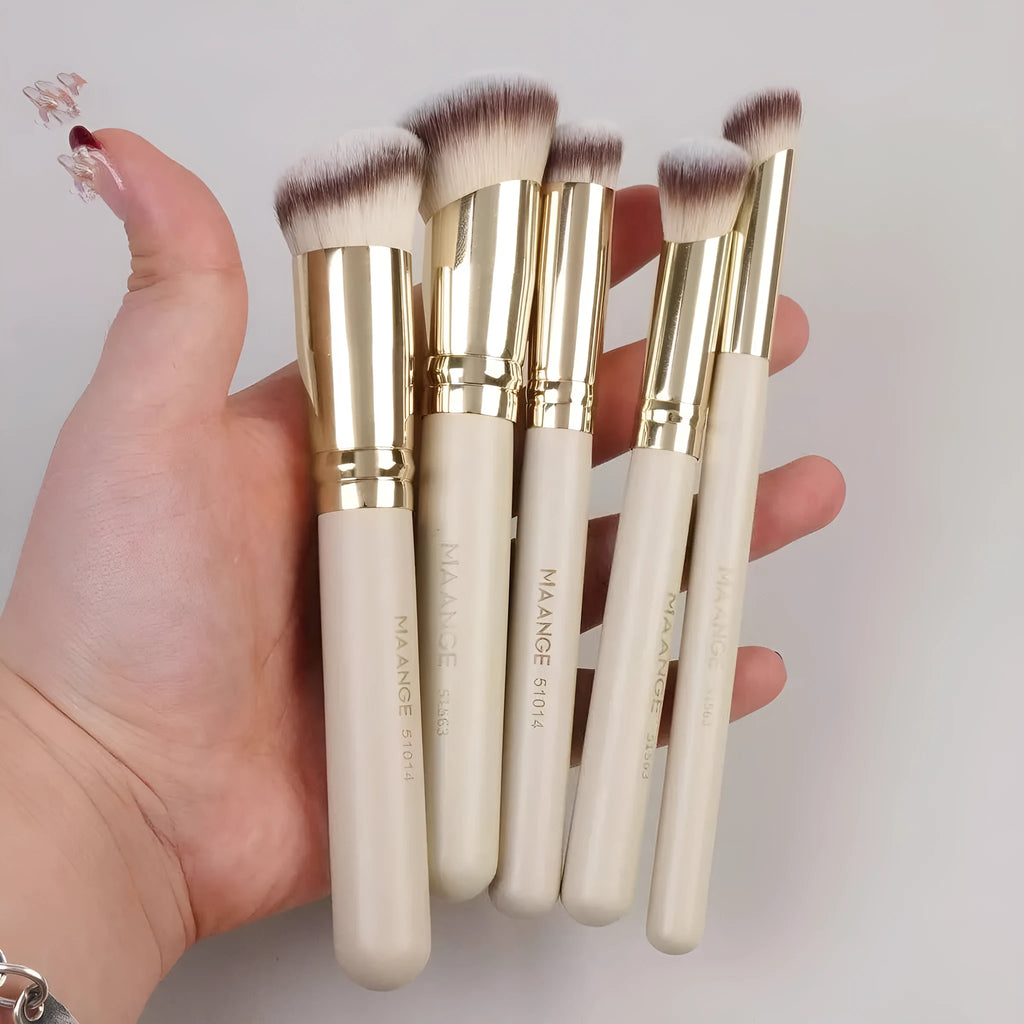 Five apricot-coloured makeup brushes including angled blusher brush for cheek application