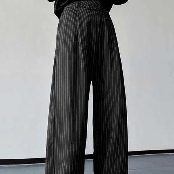 Men's black vertical striped pleated casual trousers showing elasticated waist and leg detail