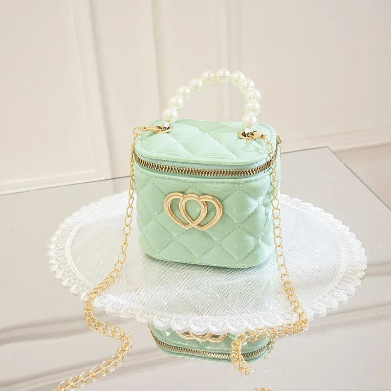 White PVC bucket bag with a heart-shaped pattern, showing its structured shape and spacious opening.