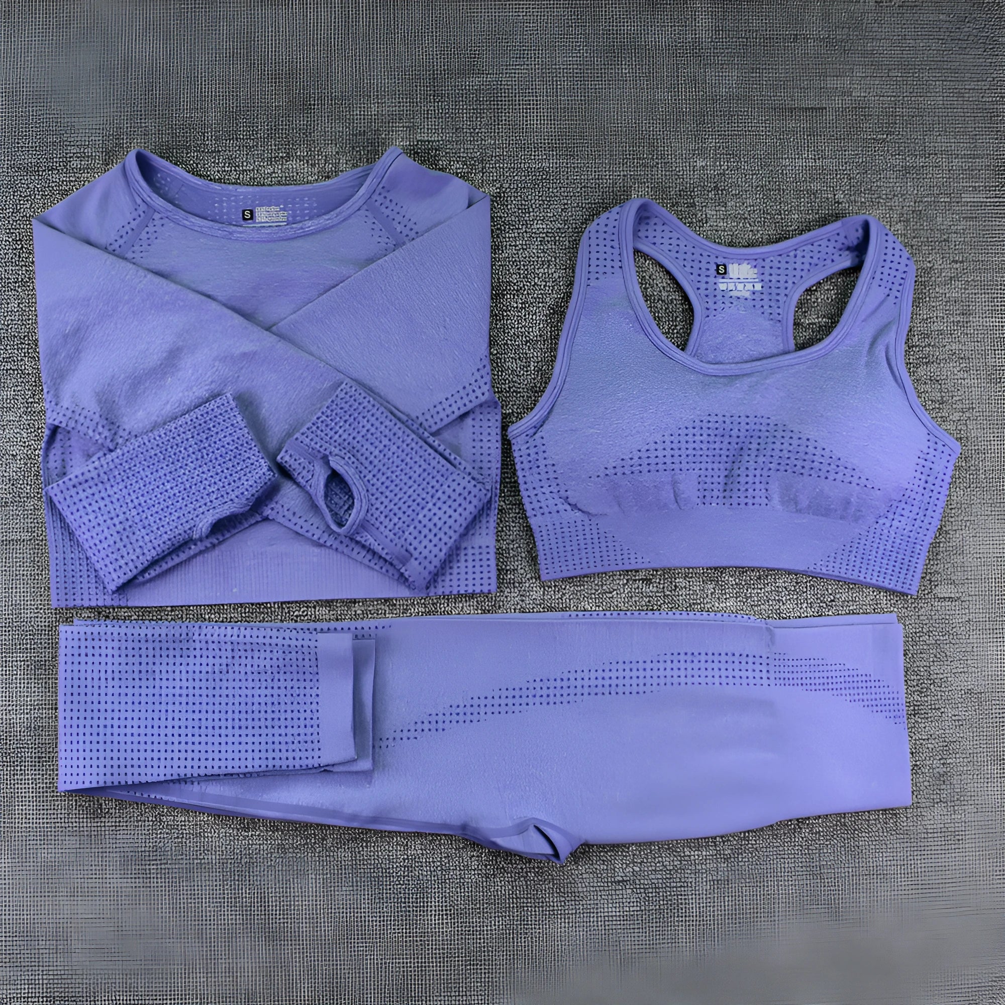 Three-piece yoga clothes set with bra, long sleeve top, and trousers in tight fit nylon blend fabric