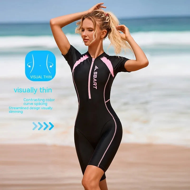 Women's solid colour one-piece surfing swimsuit with short sleeves and built-in chest pads.