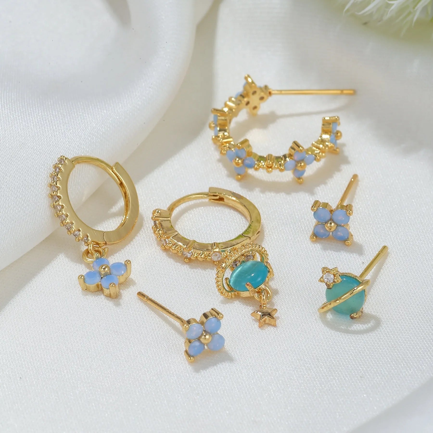 Gold and silver Japanese Korean style flower ear studs with zircon mosaic detail.