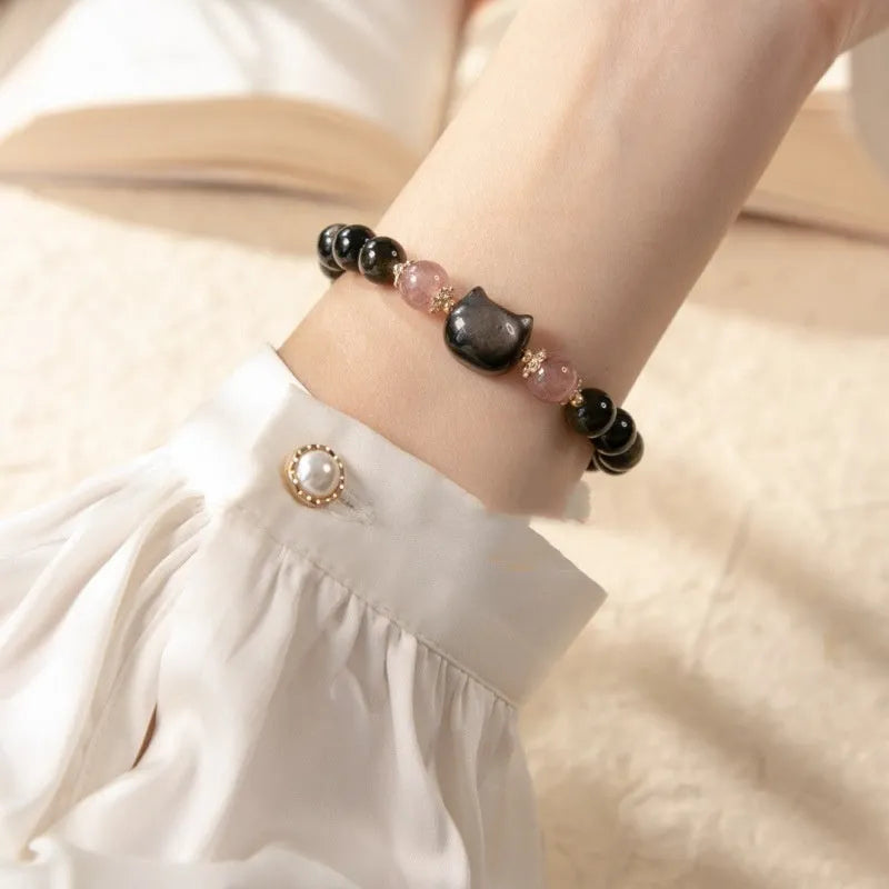 Black obsidian bracelet with 8mm beads and silver cat charms on stretch cord