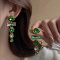 Pair of retro green gradient tassel earrings with geometric shape and inlaid zircon stones.