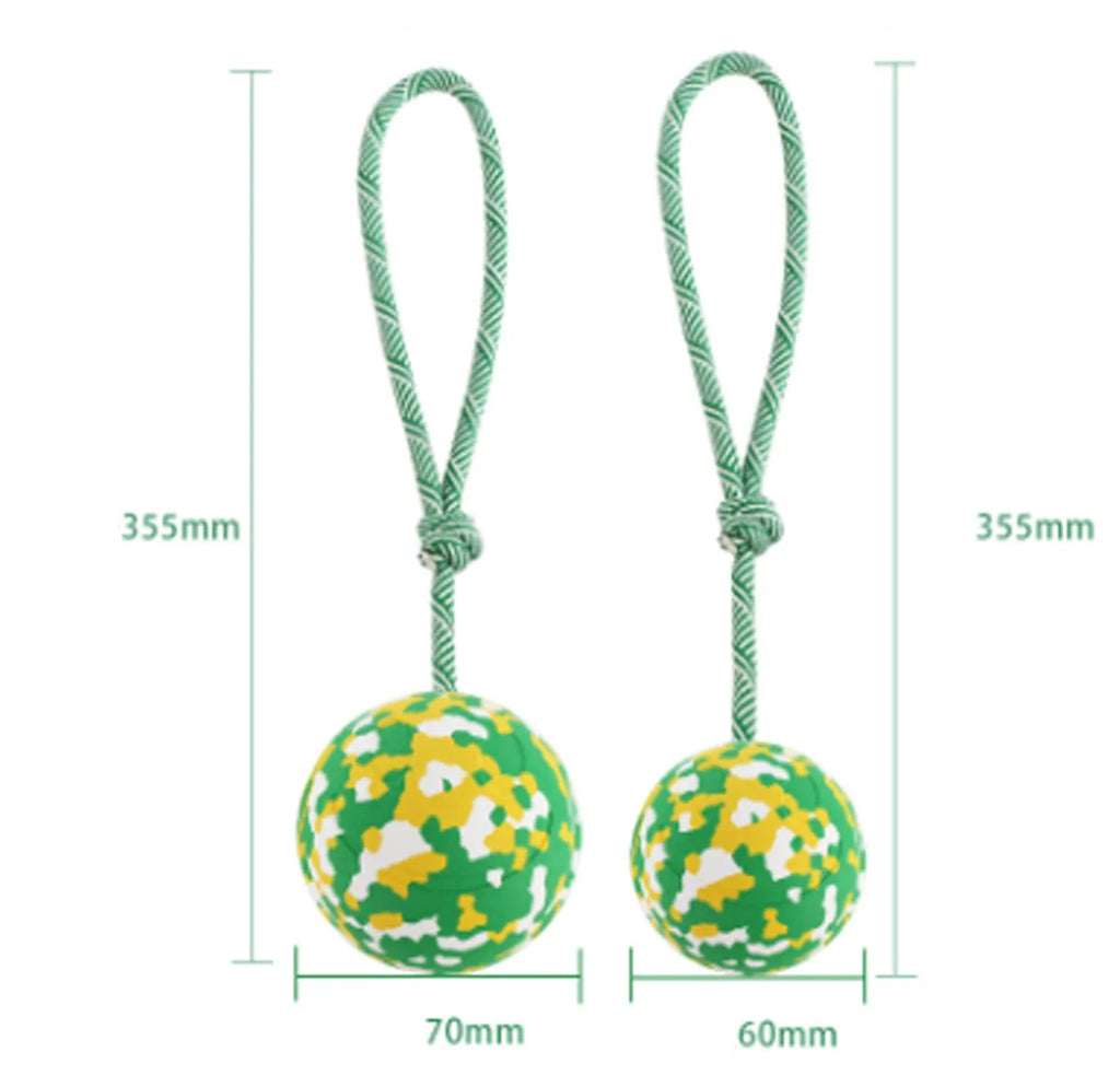 Dog toy featuring a natural rubber ball attached to a nylon rope for fetch and tug games.