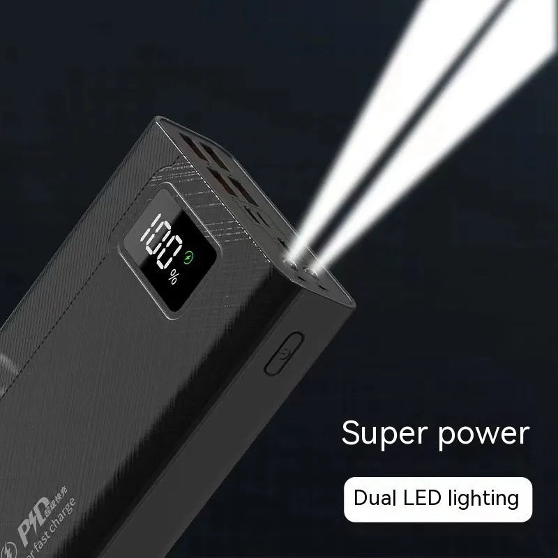 Black and white large capacity portable power bank with fast charging, showing size scale.