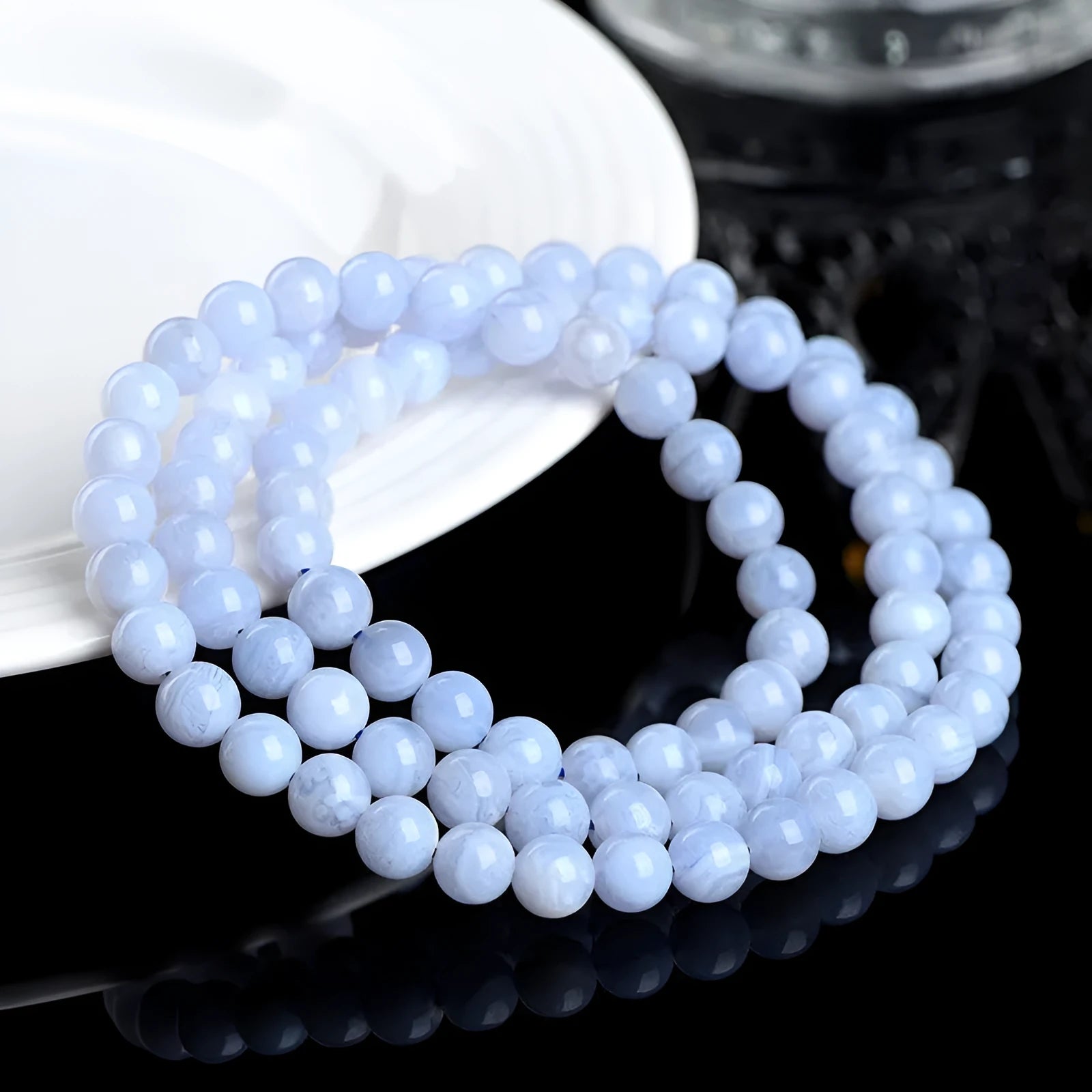 Blue agate beaded bracelet with striped patterning on 6-6.8mm beads in three circular strands