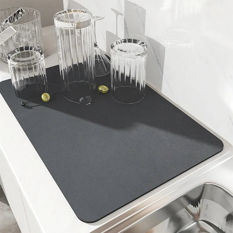 Black square super absorbent PU leather kitchen drain pad drying mat with anti-slip backing on a countertop.