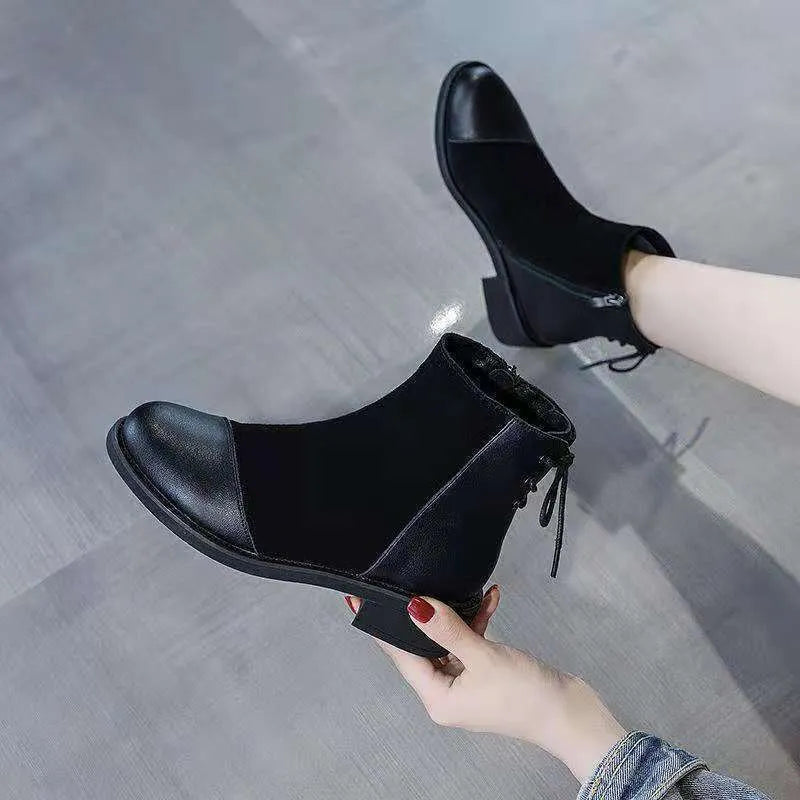 Women's black Martin boots with side zipper, non-slip rubber soles, and decorative bow detailing