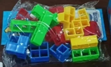 Plastic balance stacking board game with 16 colourful blocks, chassis, and base on a table.