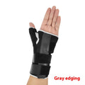 Carbon fibre sports wrist guard with thumb strap in black and grey, shown on a hand.