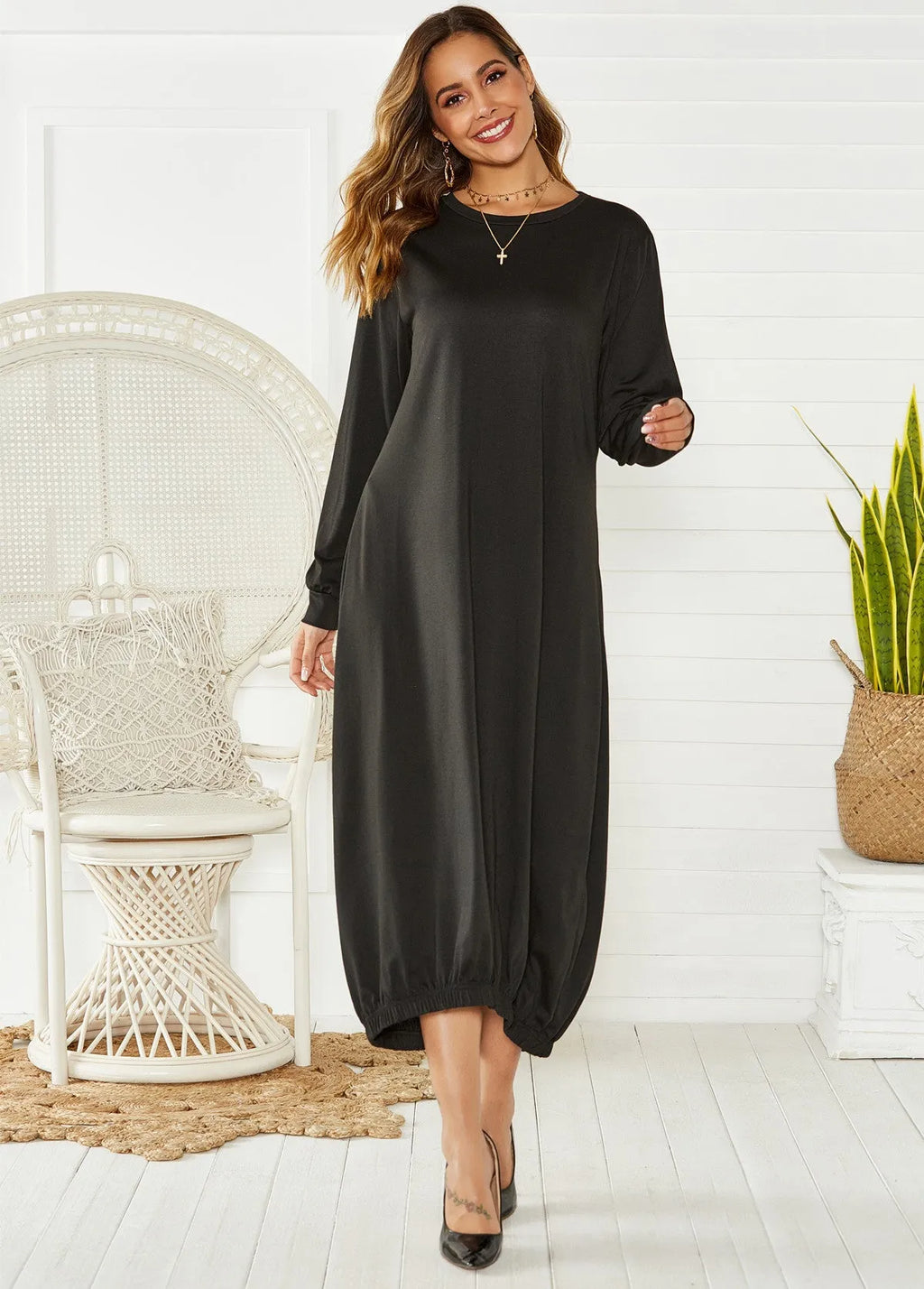 Black loose lantern dress with lace-up crew neck detail, shown on a hanger.
