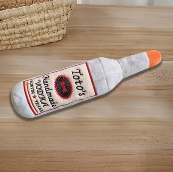 Brown wine bottle shaped plush dog toy with squeaker inside for chewing and dental cleaning