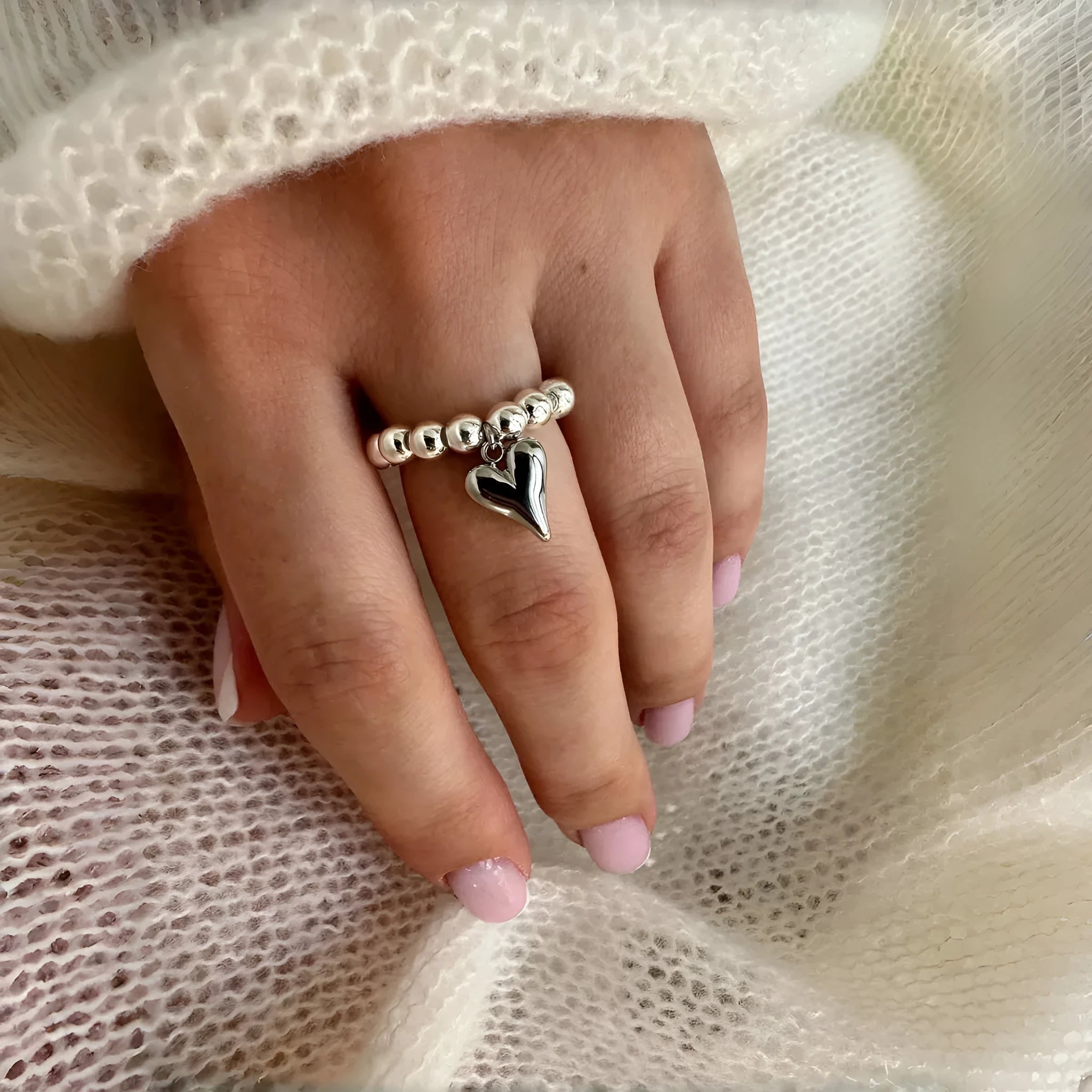 Handmade beaded elastic string love ring with geometric heart design in gold or white colours