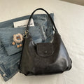 PU leather commuter backpack in horizontal square shape with single shoulder strap