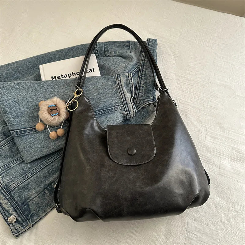 PU leather commuter backpack in horizontal square shape with single shoulder strap
