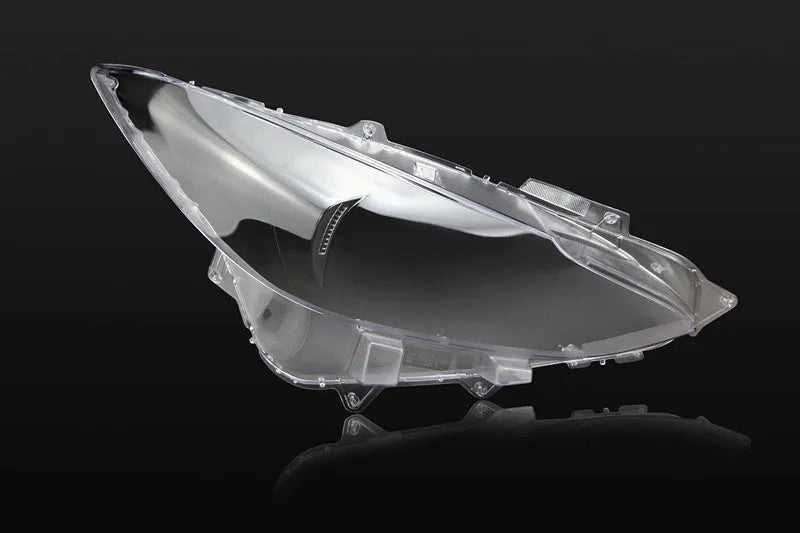 Mazda 3 Exela large headlamp cover replacement part with tube of snake glue adhesive.