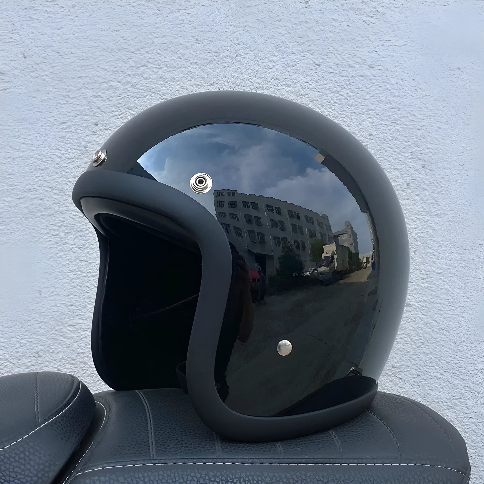 Retro-style open-face motorcycle half helmet in fibreglass, shown in a cement grey colour on a white background.