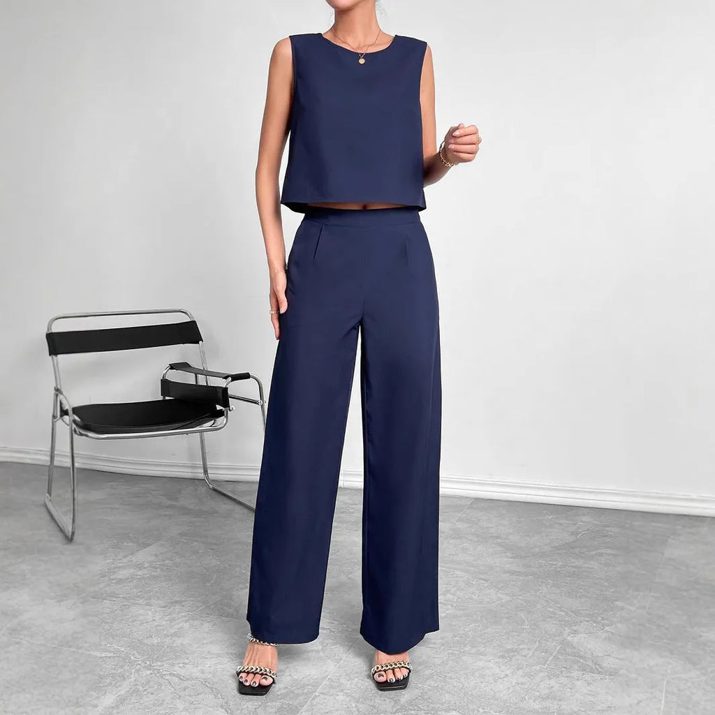 Women's red polyester two-piece set with sleeveless round-neck top and wide-leg trousers laid flat.