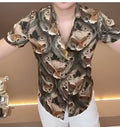 Men's printed casual button-down shirt in a contemporary pattern, made from lightweight polyester fabric.