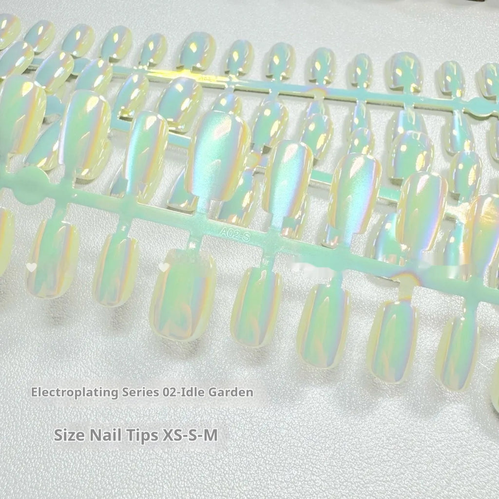 Set of electroplated Cat's Eye false nails in short ladder almond shape on a blue background, showing Aurora armour and solid colour designs.