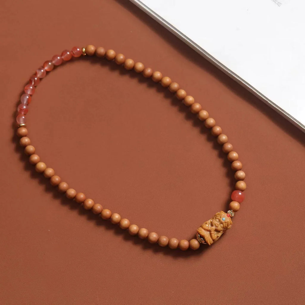 Brown sandalwood bracelet with woven South Red Zachilam design and 6mm round beads