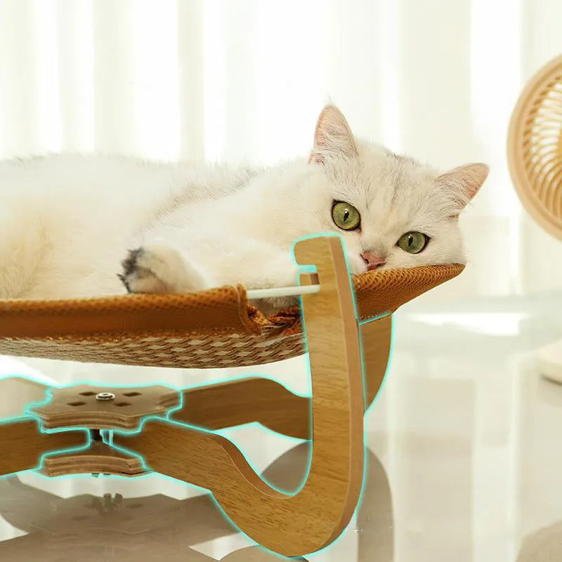 Brown woven rattan elevated hammock bed for cats and small dogs on a wooden floor.