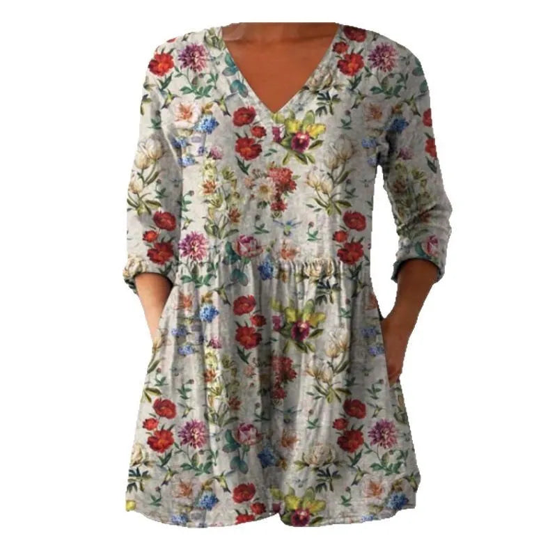 Women's loose floral print dress with wide waist and 3/4 length wave-pattern sleeves.