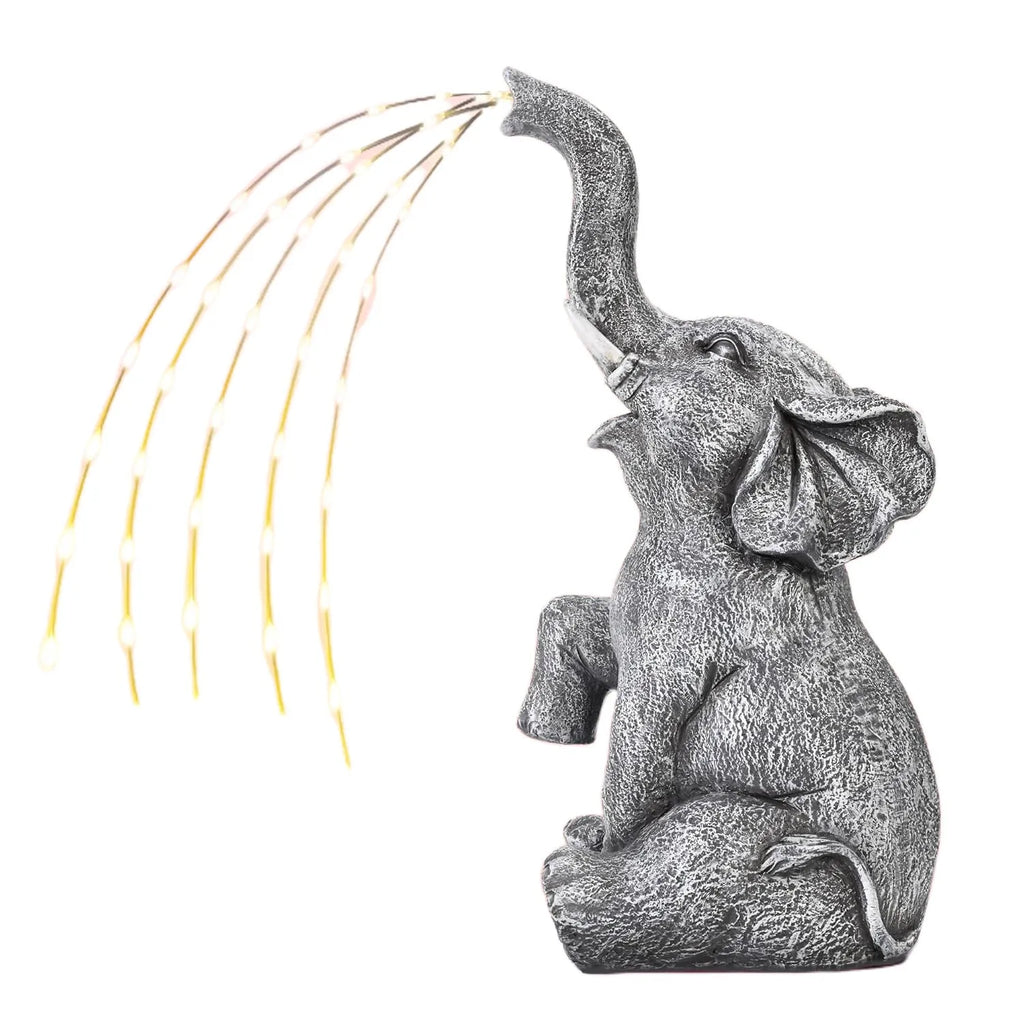 Resin elephant garden statue with a separate LED light strip on a patio.