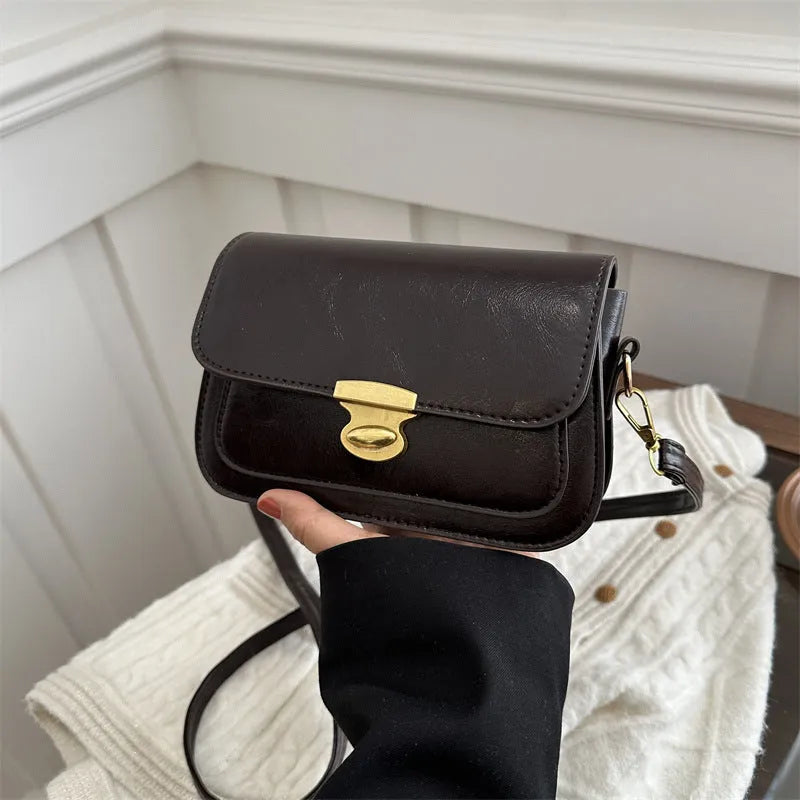 Soft PU leather small square handbag in horizontal rectangle shape shown in brown colour.