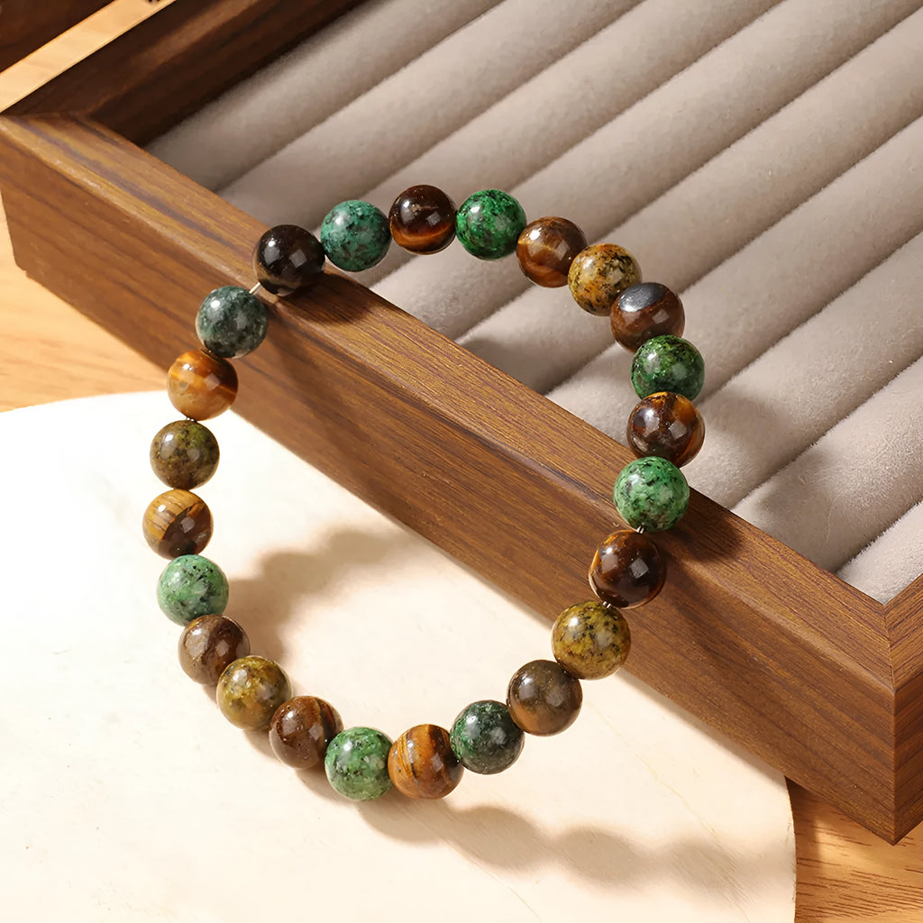 Handmade Tigereye stone bracelet with large flower-shaped bead and adjustable metal clasp on a cord.
