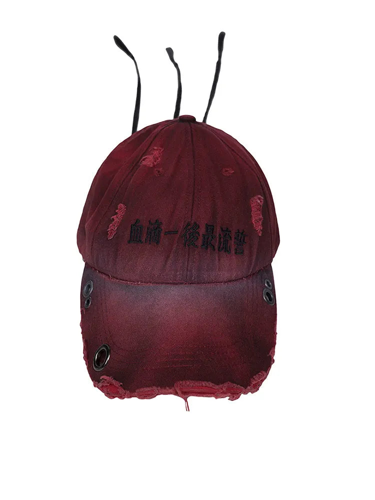 Rose red cotton peak cap with adjustable strap and spray design detail