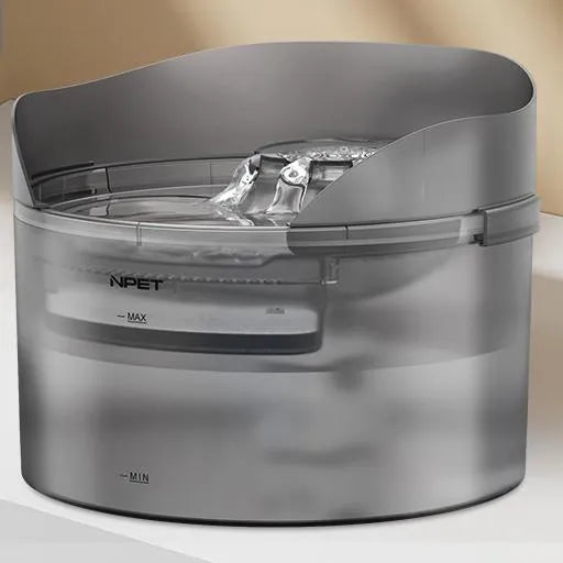 White automatic pet water fountain with flowing stream on a kitchen floor.
