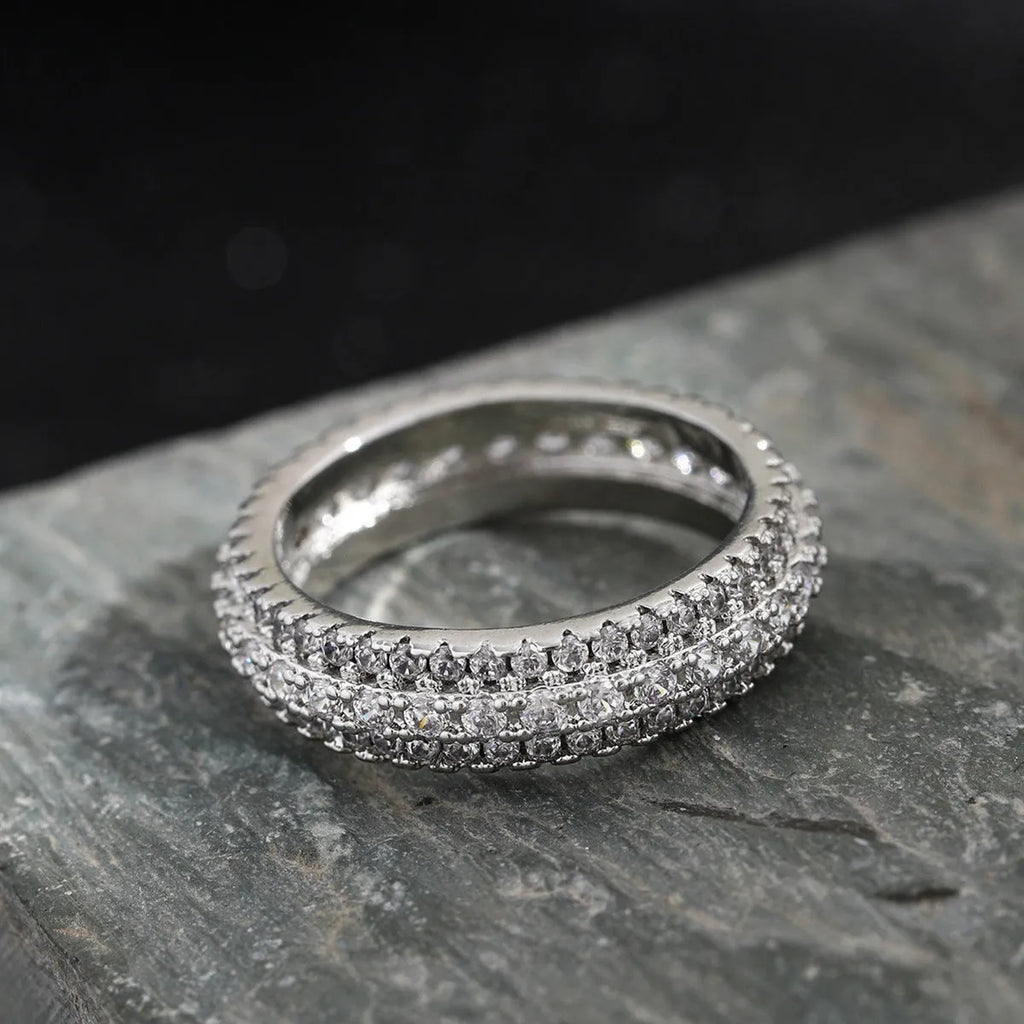 Personalised geometric ring with triangle zircon inlay in white gold finish on a hand.