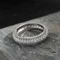 Personalised geometric ring with triangle zircon inlay in white gold finish on a hand.