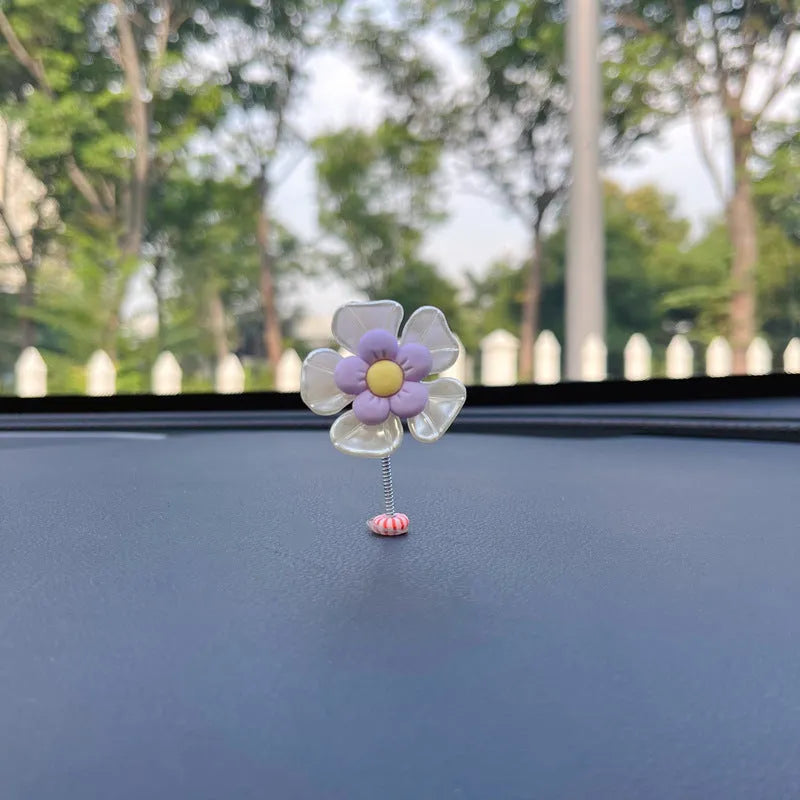 Small colourful plastic car swing decoration ornament for dashboard or shelf.