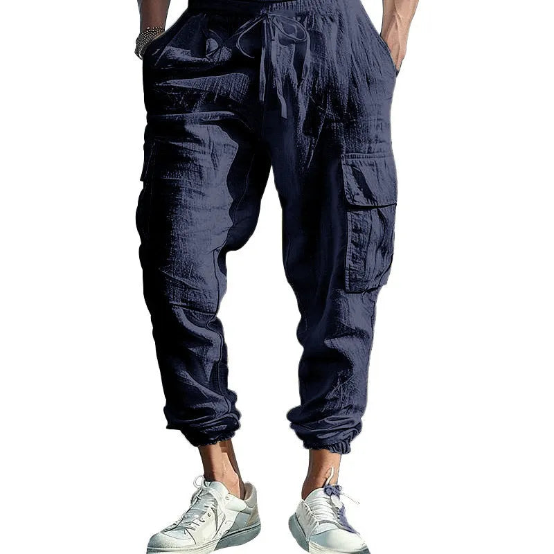 Men's linen casual trousers with ankle-tied cuffs and multiple pockets in a solid colour.