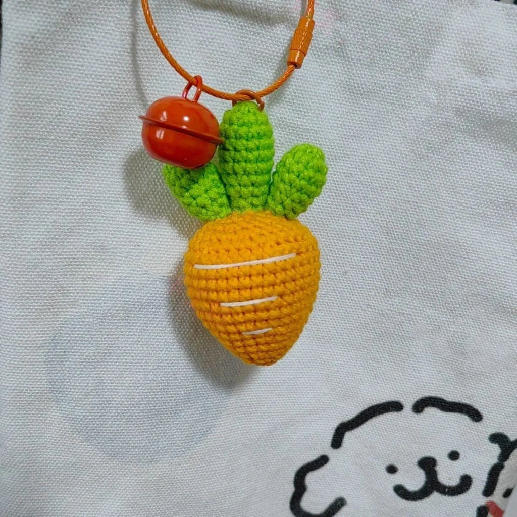 Soft wool cartoon carrot shaped keychain pendant on a keyring.