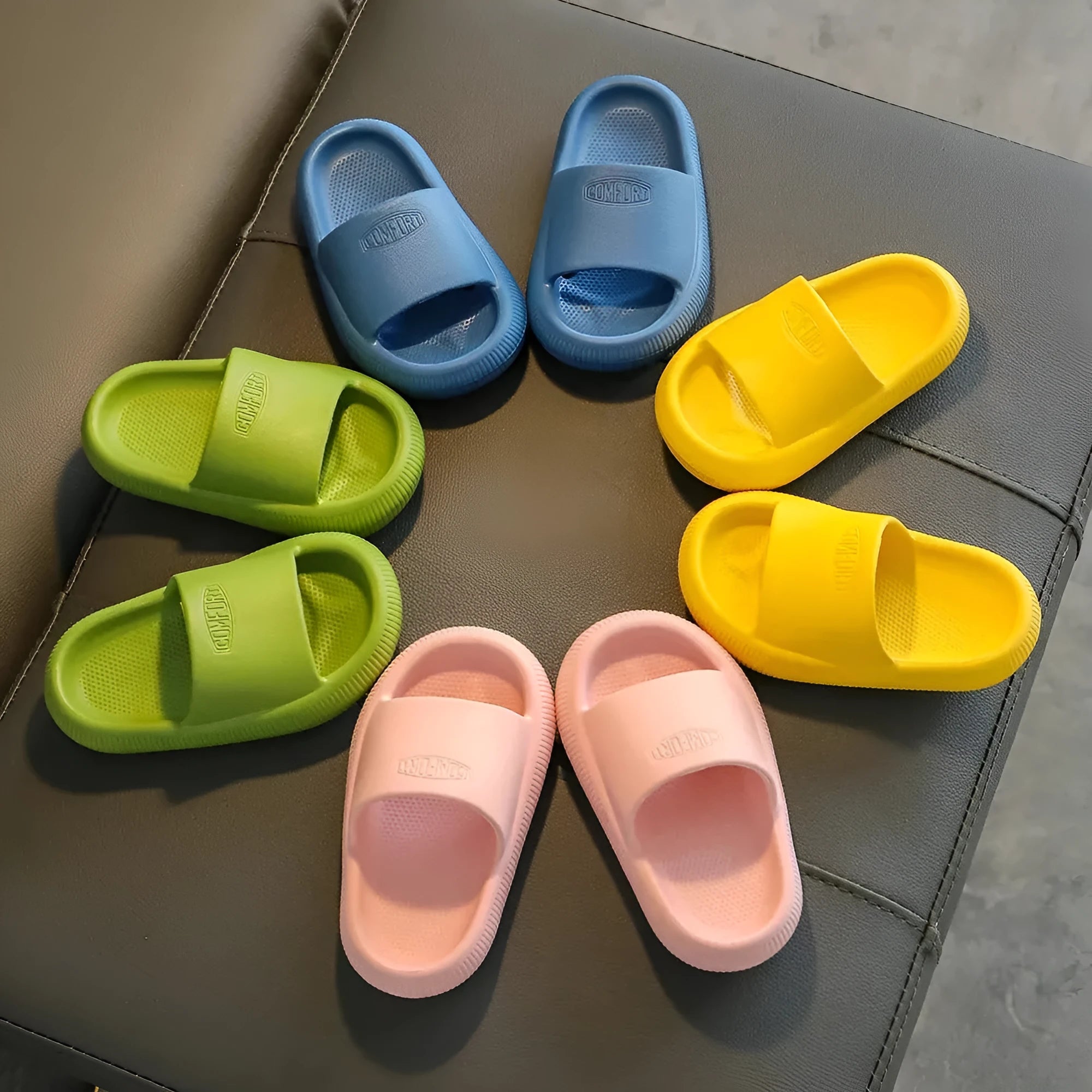 Children's bright coloured EVA slippers with a thick non-slip sole on a white background.