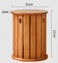 Stackable iron dining stool with large round seat in smoked black finish.